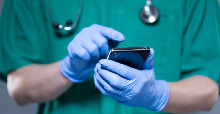 healthcare-worker-in-gloves-examining-phone.jpg