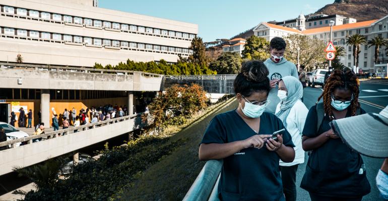 healthcare-workers-outside-Groot-Schuur-Hospital-using-their-mobile-phone.jpg