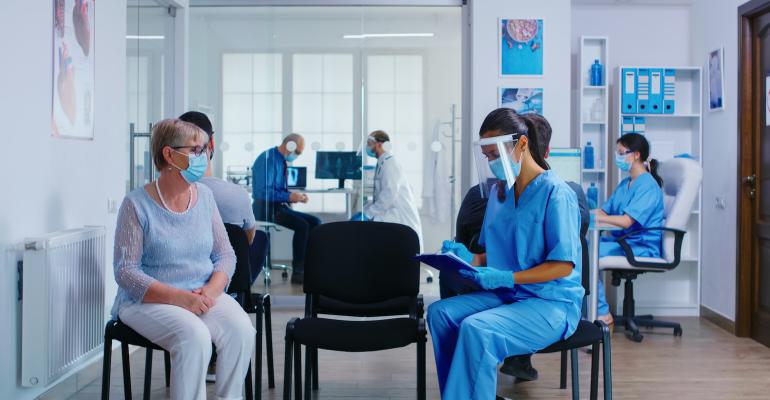 physician-and-patient-wearing-a-mask-and-maintaining-social-distancing.jpg